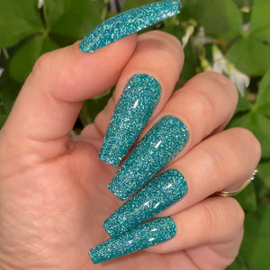 Green reflective glitter fake nails.